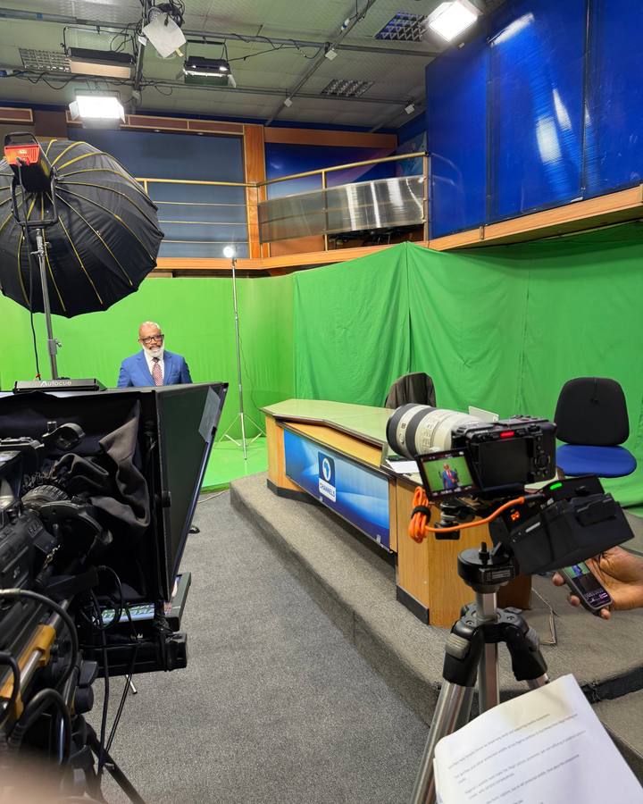 A presenter on the Channels Television studio set during a PSA shoot