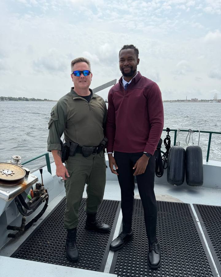 Festus Iyorah with an enforcement officer aboard a vessel